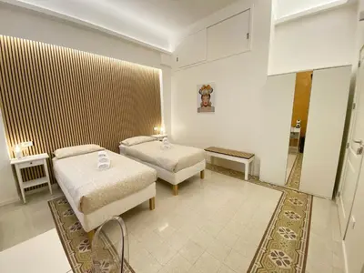 a hotel room with two beds in a room at Casa Granatelli in Palermo