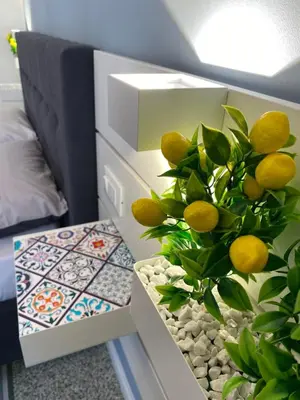 a room with a table with a plant next to a bed at Casa Granatelli in Palermo