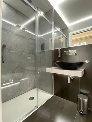 a bathroom with a shower with a glass door at Casa Granatelli in Palermo
