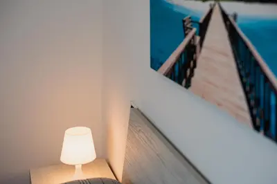 a white lamp sitting on a table next to a staircase at VILLA HEMINGWAY - LA Casa di Alessia e La Casa di Leonardo in Ficarazzi