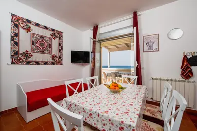 a dining room with a table with a bowl of fruit on it at VILLA HEMINGWAY - LA Casa di Alessia e La Casa di Leonardo in Ficarazzi