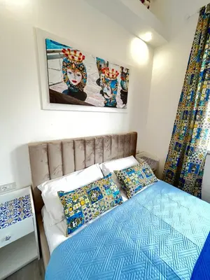 a bedroom with a bed with blue sheets and pillows at Bella Vita Palermo in Palermo