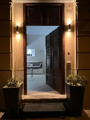 an open door to a living room with a couch at GDM central apartment Palermo in Palermo