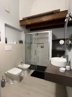 a bathroom with a toilet and a sink and a shower at GDM central apartment Palermo in Palermo