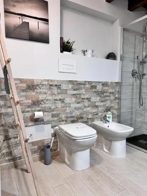 a bathroom with a toilet and a sink at GDM central apartment Palermo in Palermo