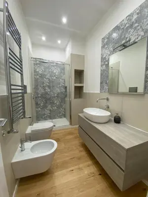 a bathroom with two sinks and a large mirror at La Piccola Formica Home in Palermo