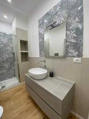 a bathroom with a sink and a mirror at La Piccola Formica Home in Palermo