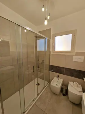 a bathroom with a shower and a toilet and a sink at Villa Fragi in Cinisi