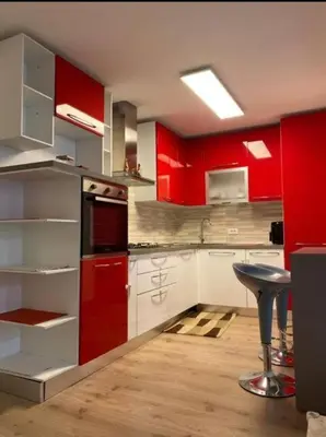 a kitchen with red cabinets and a stool in it at Prince Suite Palermo in Palermo