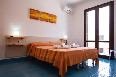 a bedroom with a bed with towels on it at Casa Orchidea Nera in San Vito lo Capo