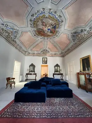 a bedroom with four beds and a painting on the ceiling at Palazzo Triolo - Dimora di Charme in Corleone