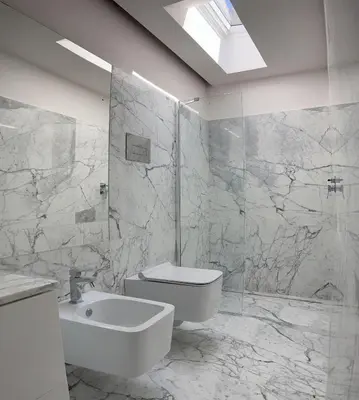 a white bathroom with a sink and a toilet at Palazzo Triolo - Dimora di Charme in Corleone