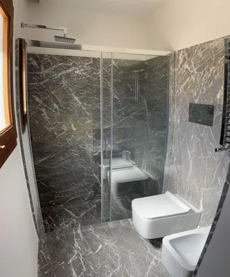 a bathroom with a sink and a shower and a toilet at Palazzo Triolo - Dimora di Charme in Corleone