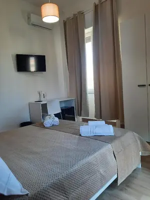 a bedroom with a large bed with two towels on it at LE CAMERE DI VIA MECCIO in Palermo