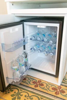 an open refrigerator filled with water bottles at B&B Handy Palermo in Palermo
