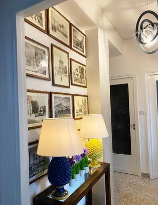 two lamps on a table with pictures on the wall at Casa Graziusa in Palermo