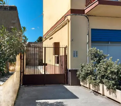 a gate to a house with a driveway at Casa Graziusa in Palermo