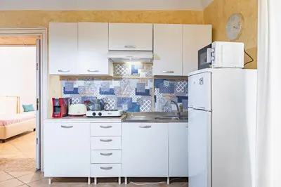 a kitchen with white cabinets and a refrigerator at Piazza Pretoria & Quattro Canti Roomy Flats with Balconies in Palermo