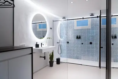 a bathroom with a shower and a sink and a mirror at Eligius Luxury Apartments in Palermo