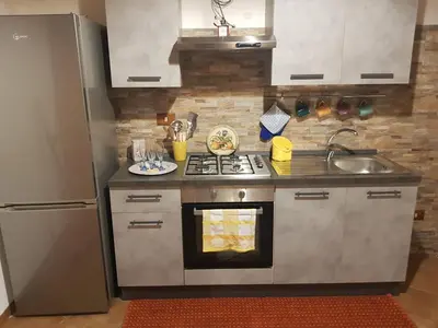 a kitchen with a stove and a refrigerator at Casa Milù in Palermo