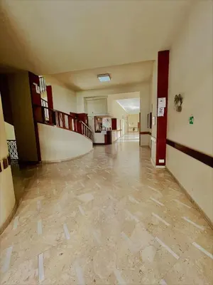 an empty hallway of a building with at wood & white home in Palermo