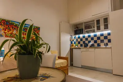 a living room with a potted plant on a table at Casa Madì in Palermo