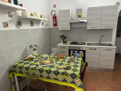 a kitchen with a table with a table cloth on it at Ninni Mondello House in Mondello