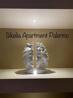 a sign that says silkella apartment palma with a vase at Sikelia Apartment Centro in Palermo