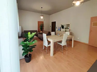 a dining room and living room with a table and chairs at ALP House in Palermo
