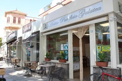 a restaurant with tables and chairs in a street at Mondello Blue Sea in Mondello