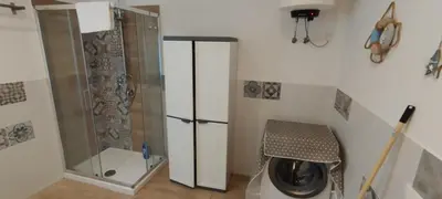 a bathroom with a shower and a washing machine at Mondello Blue Sea in Mondello