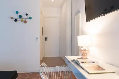 a room with a table with a lamp and a door at Libertà #102 - Guest House Palermo in Palermo
