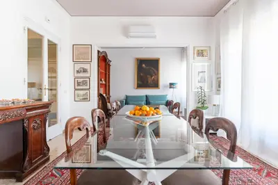 a dining room with a glass table with oranges on it at Libertà #102 - Guest House Palermo in Palermo