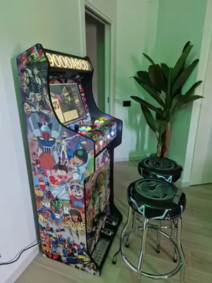 a video game machine sitting next to a stool at LA CASA DI TIAGO in Palermo