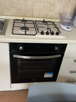 a black stove top oven in a kitchen at Le Palme House Isola delle Femmine in Isola delle Femmine