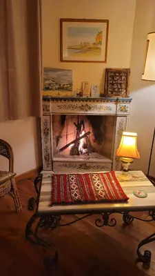 a fireplace in a living room with a fire in it at Villa Jesabel in Scopello