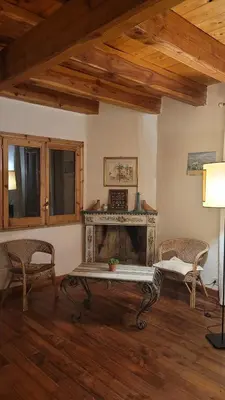 a living room with a fireplace and two chairs at Villa Jesabel in Scopello