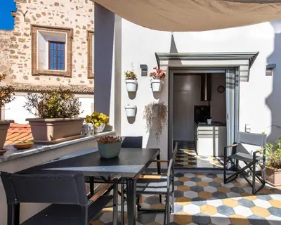 a dining room with a table and yellow chairs at Pomodoro House allo Spasimo by Wonderful Italy in Palermo