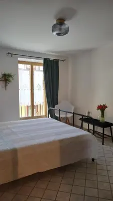 a bedroom with a large bed and a window at Pia's Home in pieno centro storico in Palermo