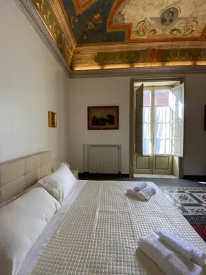 a bedroom with a bed with two towels on it at Amari 106 in Palermo