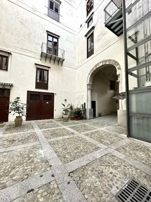 an empty courtyard of a building with a building at Casa Guilla_alla Cattedrale in Palermo