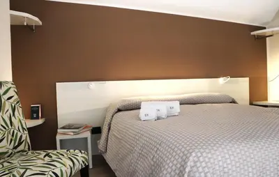 a bedroom with a bed with two towels on it at Elimi Home Appartamenti in Nuova Gibellina