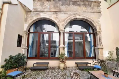 a building with windows and benches in front of it at iFlat agli Archetti del centro in Palermo