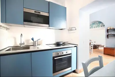a kitchen with blue cabinets and a sink at iFlat agli Archetti del centro in Palermo