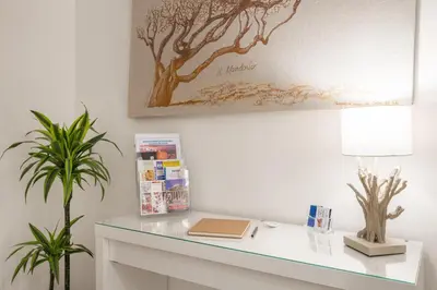 a desk with a lamp and a book on it at Iverlid Home. in Palermo